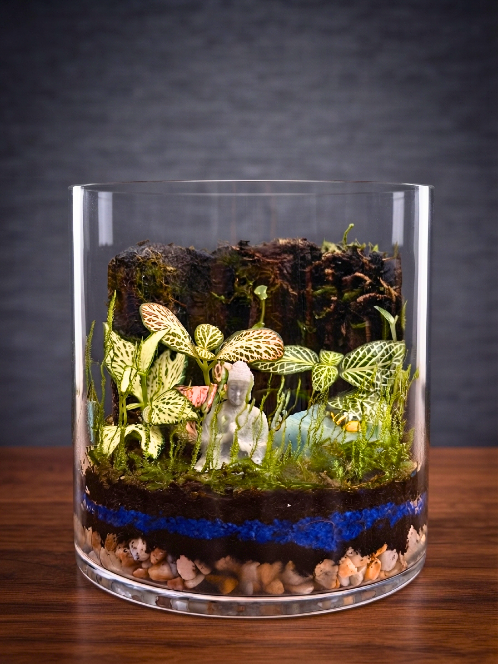 Handcrafted glass terrarium with Buddha centerpiece, Fittonia red green and decorative moss layers