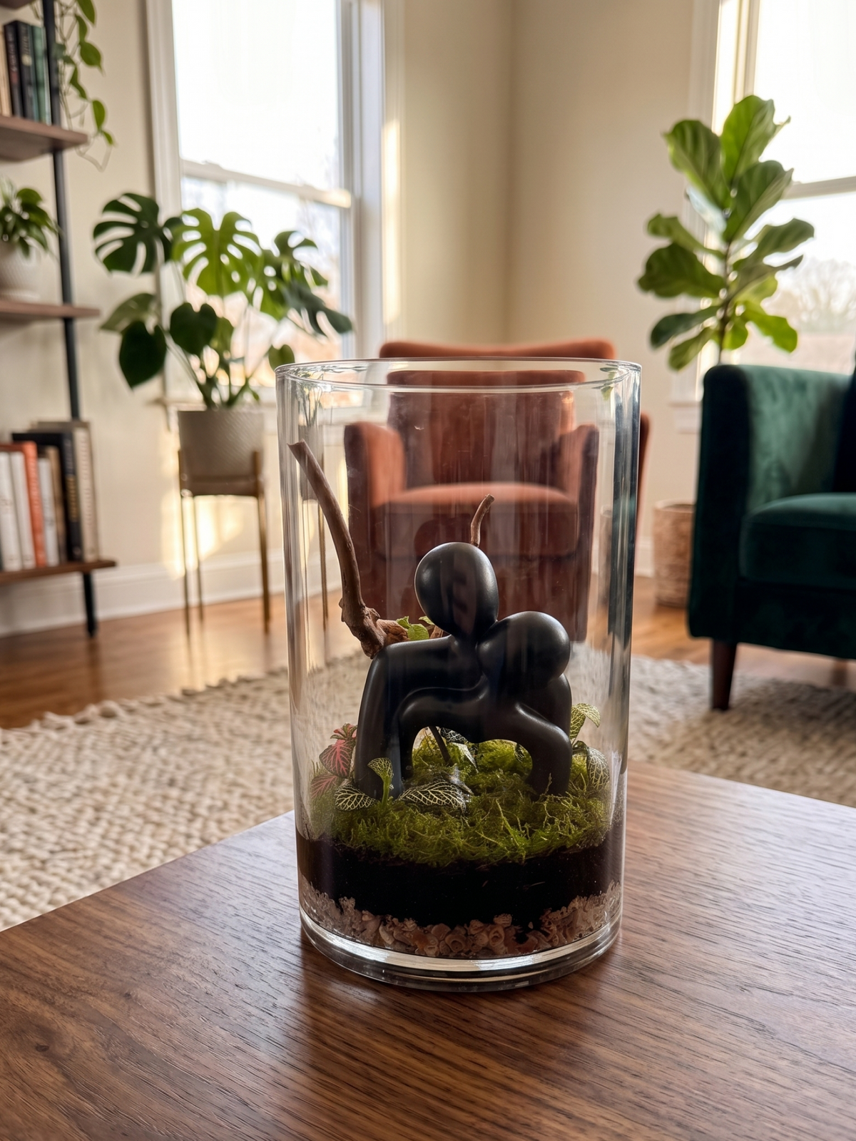 Modern indoor Embracing Haven terrarium display with an abstract embracing couple statue surrounded by tropical foliage. Lilli Plants Dubai