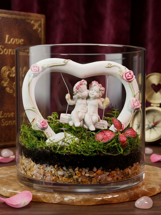 Love Nest Mini Cylinder Terrarium with couple on heart swing, Fittonia Red, and premium moss – romantic décor in Dubai & UAE