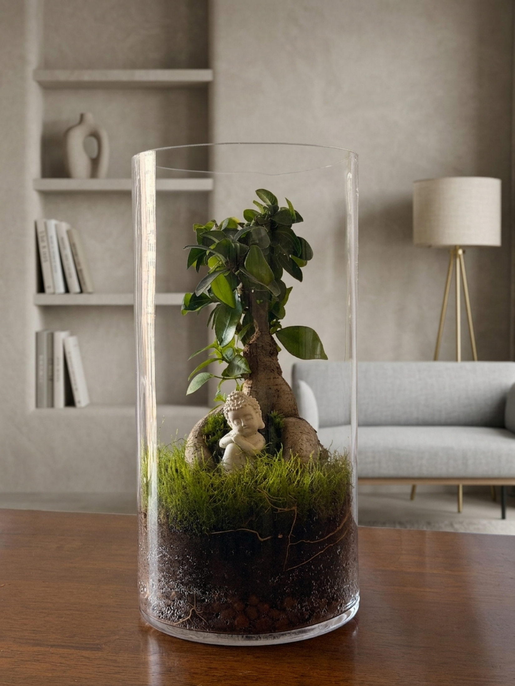 Zen-inspired cylinder terrarium with resting Buddha, mature Ficus bonsai, flat moss, and cushion moss handcrafted in Dubai.